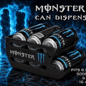 May include: A black plastic Monster can dispenser featuring the Monster logo and text. The unit holds six cans, compatible with 16 oz and 500 ml sizes. The dispenser has a tiered design with horizontal slots, displaying the Monster branding in white.