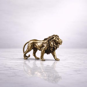 May include: A detailed bronze lion figurine in a walking pose. The sculpture has a textured mane and body, with visible muscle definition. The lion is set against a white marble surface, with its reflection subtly visible.