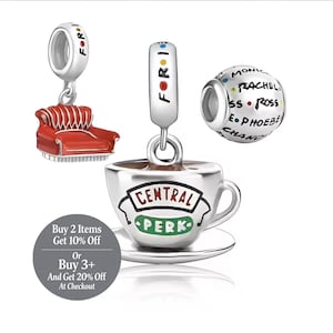 May include: Silver charm set featuring iconic elements from the TV show "Friends." Includes a red couch, a coffee cup with "Central Perk" logo, and a charm with the names of the characters. The charms are connected with the word "FOR".