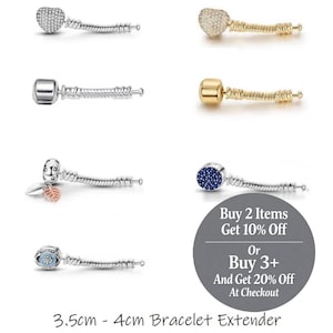 May include: A collection of bracelet extenders, each with a unique decorative end. Styles include heart-shaped, round, and cylindrical designs, some adorned with crystals or a textured finish. The extenders measure 3.5cm to 4cm in length.