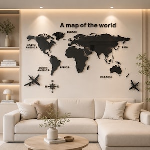 May include: A black acrylic world map wall art installation featuring the text A map of the world, continent labels, a compass rose, and two airplane silhouettes. The map displays North America, South America, Europe, Africa, Asia, and Oceania.