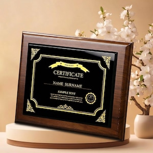 May include: A wooden certificate frame with a black background and gold detailing. The certificate reads "CERTIFICATE" with space for a name and sample text. The frame is brown and has a polished finish.