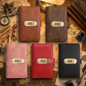 May include: Five leather journals in various colors: brown, dark brown, pink, red, and black. Each journal features a combination lock closure and a textured surface. The journals are displayed on a map.