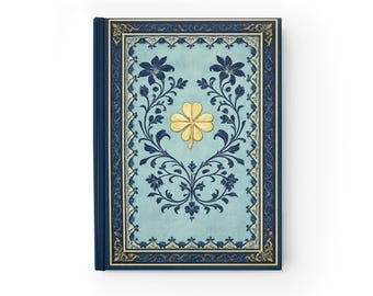 Cuaderno decorativo azul vintage con diseño floral y trébol dorado del grimorio de la suerte