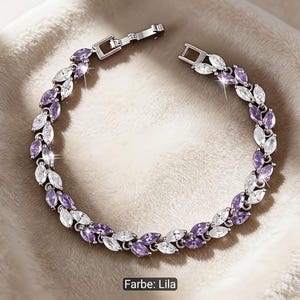 Puede incluir: Una pulsera de tono plateado con un patr&oacute;n repetitivo de piedras de corte marquesa en colores alternos morado claro y blanco transparente. La pieza de joyer&iacute;a incluye un cierre de metal y est&aacute; dispuesta en forma circular sobre una superficie.