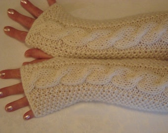 May include: A pair of white knitted fingerless gloves with a cable knit pattern.
