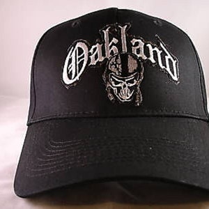 May include: Black baseball cap with a white embroidered skull and the word "Oakland" in a stylized font.