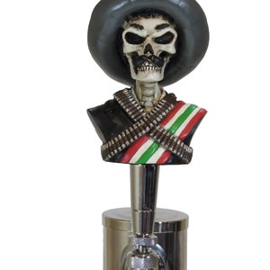 May include: A grey sombrero-wearing skeleton bust with a black jacket, white and green sash, and a silver beer tap.
