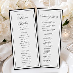 May include: Two elegant wedding programs with black borders, featuring names, date, location, and ceremony details. The programs are set on a white table with floral arrangements and glassware. The text includes "Monica & Andrew" and "Wedding Party."