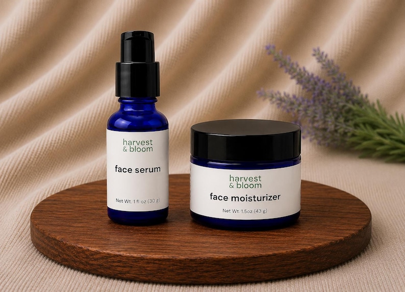 May include: A blue glass bottle of face serum with a black pump and a blue glass jar of face moisturizer with a black lid. The serum label reads harvest & bloom face serum Net Wt. 1 fl oz (30 g) and the moisturizer label reads harvest & bloom face moisturizer Net Wt. 1.5 oz (43 g).