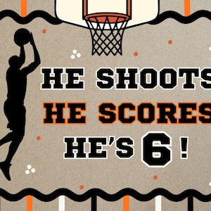 May include: A basketball-themed graphic with a silhouette of a player shooting a ball towards a hoop. Text reads "HE SHOOTS HE SCORES HE'S 6!" in black and orange. The background is tan with orange and white accents.