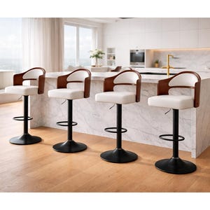 May include: Four modern bar stools with white seats, dark wood armrests, and black bases. The stools have a curved back design and a footrest. They are arranged in a row in front of a kitchen island.