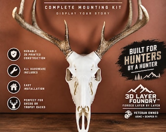 May include: A white 3D printed deer skull mount with natural antlers, labeled EUROMOUNT COMPLETE MOUNTING KIT. Text includes BUILT FOR HUNTERS BY A HUNTER, 3D LAYER FOUNDRY, and VETERAN OWNED USMC SEMPER FI, with icons for durable construction and hardware.