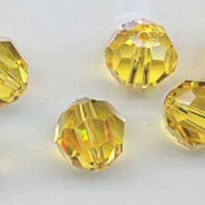 Twelve vintage Swarovski crystals: art 5000 - 10mm - discontinued color light topaz AB