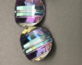 May include: Three iridescent glass beads with a striped pattern in shades of blue, purple, and green.