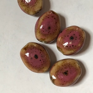 Fourteen lovely porcelain/ceramic beads - pink spattered and speckled with golden brown - 14 x 12 mm flattened ovals