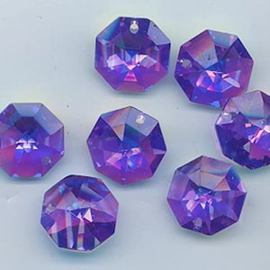 May include: Eight iridescent purple octagon-shaped crystal beads with a hole at the top for stringing.