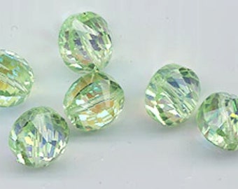 May include: A group of six light green faceted glass beads with iridescent shimmer.
