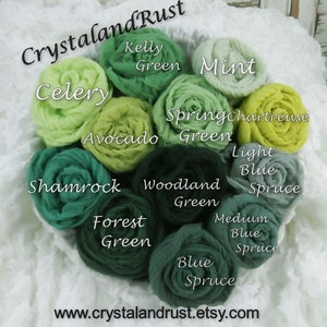 May include: A bouquet of 10 fabric rosettes in shades of green and blue, including celery, kelly green, mint, spring chartreuse, avocado green, shamrock, woodland green, forest green, light blue spruce, medium blue spruce, and blue spruce. The rosettes are arranged in a circle with the text "Crystaland Rust" at the top and "www.crystalandrust.etsy.com" at the bottom.