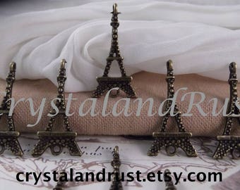 May include: Six antique gold Eiffel Tower charms with a textured surface. The charms are approximately 2 inches tall and are perfect for jewelry making or scrapbooking.