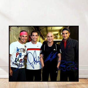 May include: A framed photograph featuring four tennis players, each with a signature in blue ink. The players are standing in a tunnel, with a light at the end. One player wears a white t-shirt with blue text, another a white shirt with a red stripe.