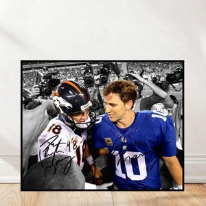 May include: Black and white framed photograph featuring two football players in their jerseys. One player wears a blue jersey with the number 10, and the other wears a white and orange jersey with the number 18. Both jerseys are signed.