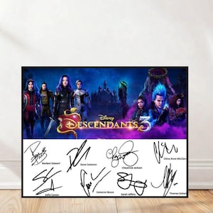 May include: A framed poster featuring the Disney movie "Descendants 3." The poster has a dark blue background with character images and the movie title. Below the image are signatures of the cast members, including Dove Cameron and Sofia Carson.