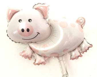 Könnte beinhalten: Ein rosa-weißer Schweineballon mit rosa Punkten. Der Ballon hat ein lächelndes Schweinegesicht mit einer rosa Nase und einer rosa Schleife.