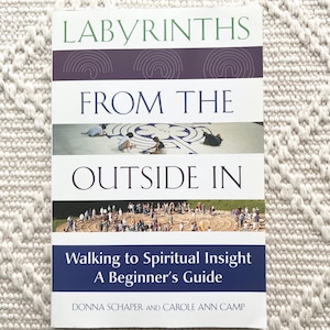 May include: A book titled "Labyrinths From The Outside In" with a blue and white cover. The book's cover features images of people walking in labyrinths. The text "Walking to Spiritual Insight A Beginner's Guide" is also visible.