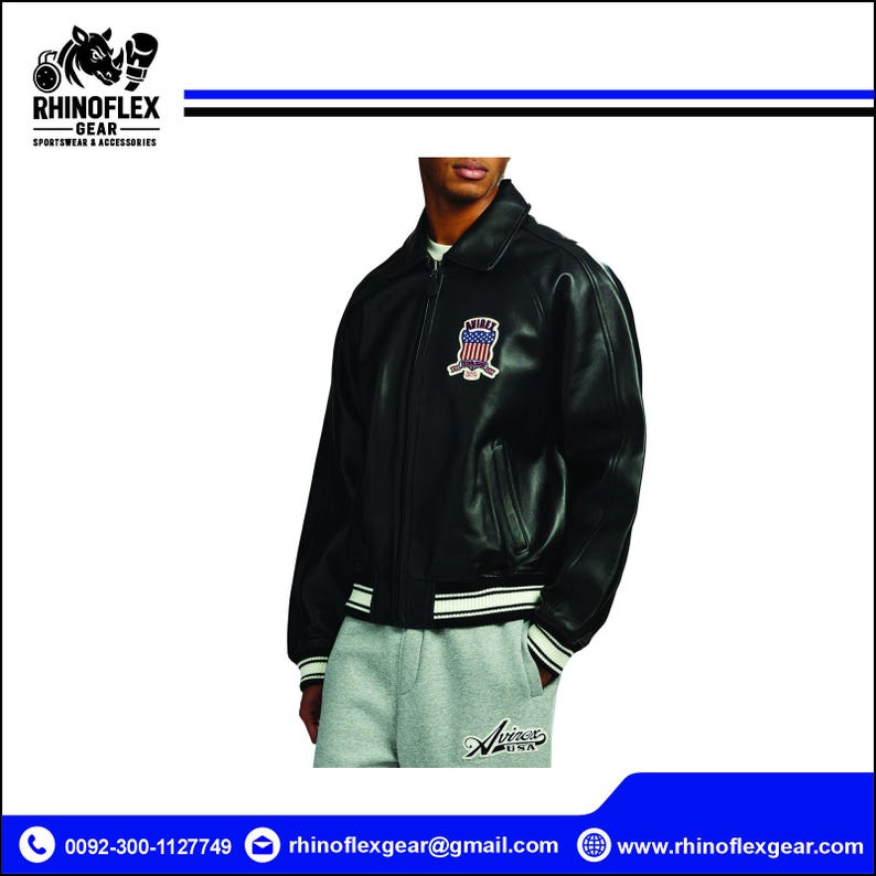 May include: A black leather jacket with a fold-down collar, long sleeves, and ribbed cuffs. The jacket features a patch on the left chest displaying an American flag design with the text Avirex. It is worn over light grey sweatpants with Avirex USA text.