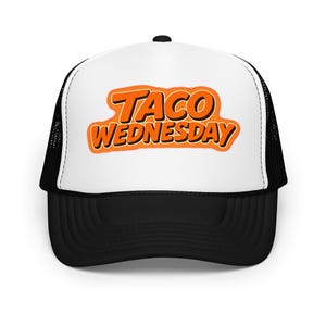 May include: A black and white trucker hat featuring the text "TACO WEDNESDAY" in orange. The hat has a white front panel and a black mesh back, a classic design.