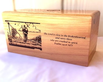 May include: Light brown wooden box with an engraved illustration of a person walking on railway tracks. The text "The Lord is close to the brokenhearted" is also engraved on the box.