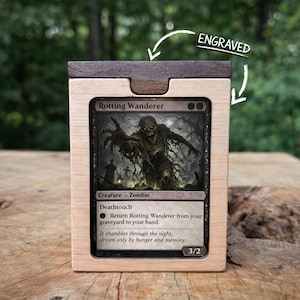 May include: A wooden card holder with a card featuring a zombie illustration. The card is labeled "Rotting Wanderer" and includes game text. The top of the holder is engraved with the word "ENGRAVED".