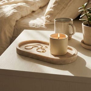 May include: A set of three ceramic mugs with a speckled, matte finish. The mugs are in shades of cream, light gray, and dark gray. Each mug has a simple, minimalist design, perfect for coffee or tea.