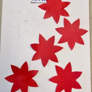May include: Red glitter star-shaped appliques on white paper. One star is a pencil outline. The text "Creations by Melodie" and "APPLIQUE Ready to iron in place" are visible. These appliques are ideal for crafting and holiday decorations.