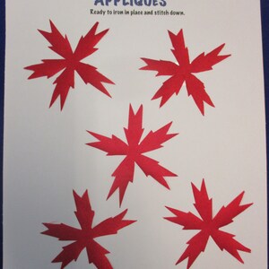 May include: Five red felt appliques in the shape of a star with jagged edges. The appliques are ready to iron on and stitch down. The text "APPLIQUES" is written in blue letters above the appliques. The text "Creations by Melodie" is written in black letters above the text "APPLIQUES". The text "Ready to iron in place and stitch down." is written in black letters below the text "APPLIQUES".