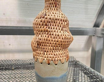 Handmade ceramic vase with woven bamboo