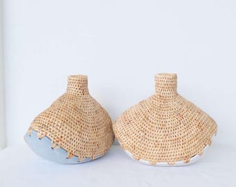 Handmade vase made of water hyacinth fiber combined with ceramic.