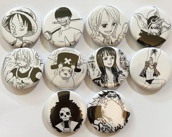 Puede incluir: Una colección de diez botones redondos blancos con ilustraciones en blanco y negro de personajes de anime. Cada botón muestra un diseño de personaje diferente, con diversas expresiones faciales y poses. Los botones están dispuestos en un patrón de cuadrícula.