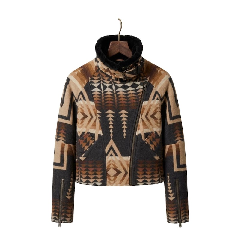 May include: A cropped jacket featuring a geometric pattern in shades of brown, tan, and charcoal gray. The jacket has a high collar lined with black faux fur, an asymmetrical front zipper closure, and long sleeves with zippered cuffs at the wrists.