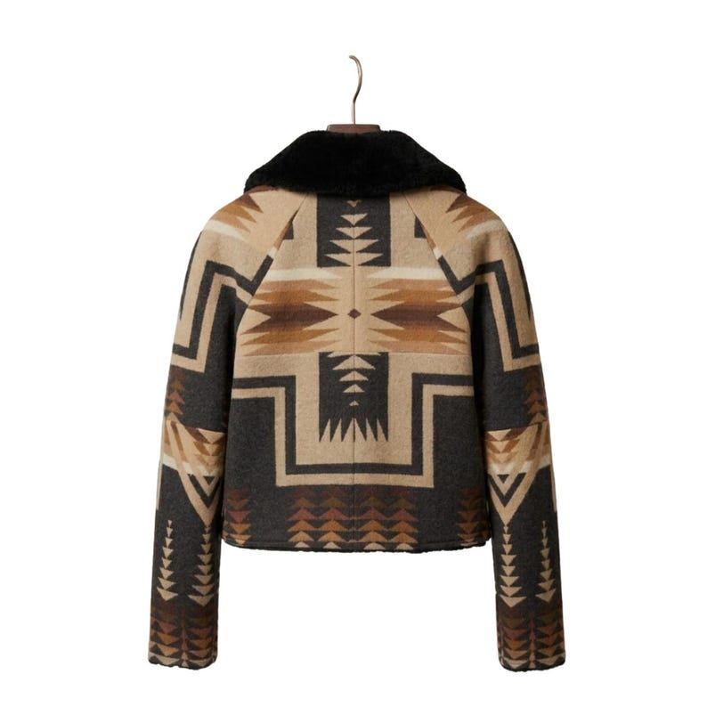 May include: A jacket featuring a black faux fur collar and a geometric pattern in shades of tan, brown, and charcoal gray. The garment has long sleeves and a straight hem, displaying a symmetrical design across the back and sleeves.