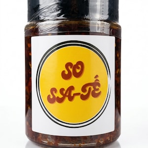 May include: A white ceramic mug with a black handle and the text "But First, Coffee" in a bold, black font. The mug is set against a neutral background, highlighting its simple design.