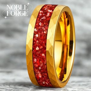May include: A gold-colored ring with a hammered texture and a vibrant red stone inlay. The ring features the text "NOBLE FORGE BANDS". The band's design showcases a bold, eye-catching aesthetic, perfect for a statement piece.