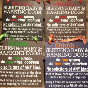 May include: Four rectangular wooden signs with text in white, red, green, and orange. The signs read "Shhh... SLEEPING BABY & BARKING DOGS! do not knock do not ring doorbell No solicitors of ANY kind."