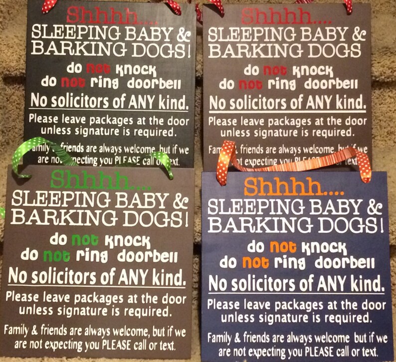 May include: Four rectangular wooden signs with text in white, red, green, and orange. The signs read "Shhh... SLEEPING BABY & BARKING DOGS! do not knock do not ring doorbell No solicitors of ANY kind."