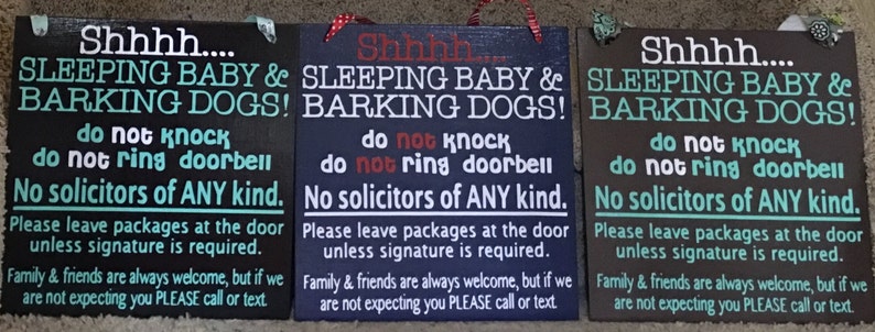May include: Three wooden signs with the text "Shhhh... SLEEPING BABY & BARKING DOGS!" and other instructions. The signs are in black, navy blue, and brown, with white and teal lettering. Each sign has a decorative top.