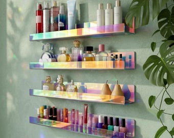 May include: Four iridescent floating shelves mounted on a light green wall, displaying various beauty products. The shelves hold perfumes, lotions, nail polish, and decorative pears. The shelves have a rainbow finish.