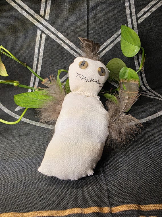 A hand-stitched folk art voodoo doll that looks genuinely handmade and weird — the kind of thing that earns a double-take on any curiosity shelf.