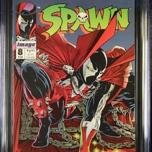 May include: A CGC graded 9.6 Spawn number 8 comic book featuring a cover illustration of the character Spawn in a red cape and black suit with silver chains. The comic displays the title Spawn in green letters with a skull icon and the date February.