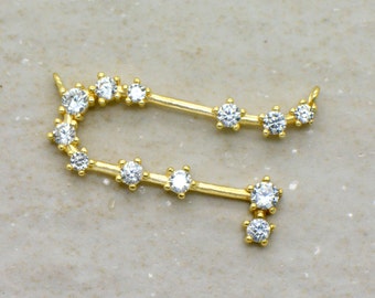 May include: Gold-toned pendant featuring a constellation design with clear cubic zirconia stones.